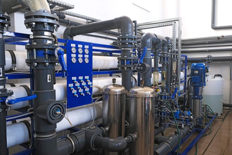 inside room of wastewater treatment facility with pipes and many manometer indicators, sensors, sampler and rotameters, water filtration factory